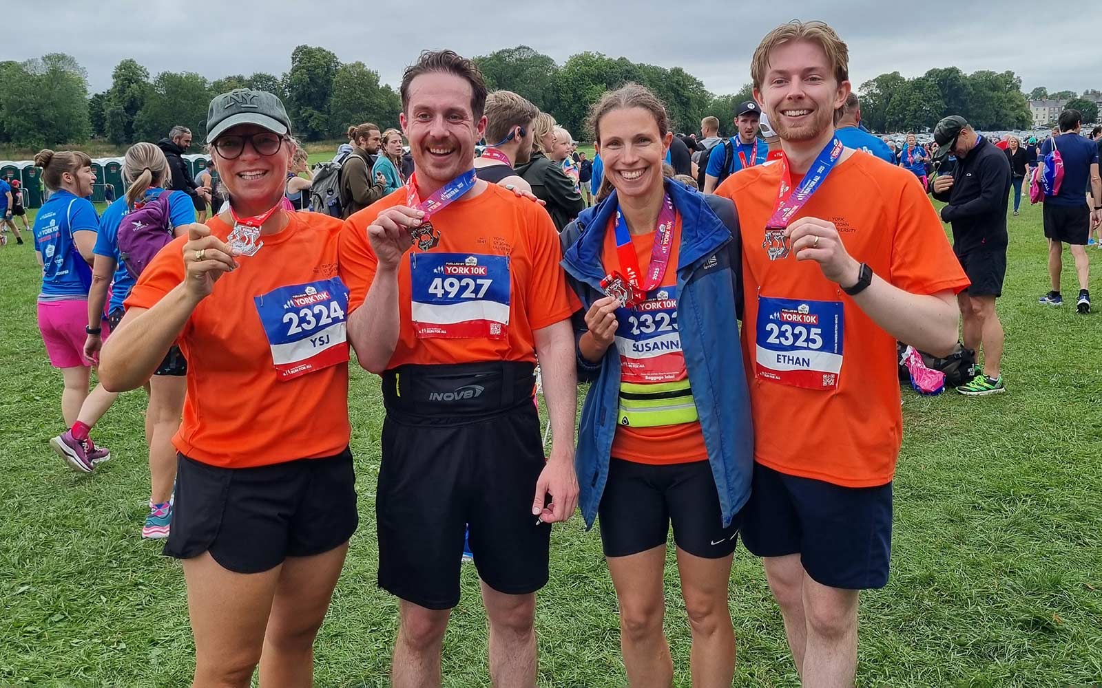 Team of staff holding medals after completing York 10K 2025