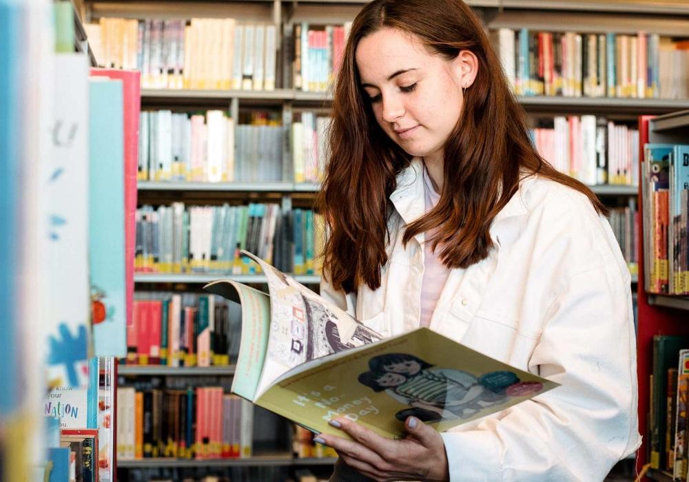 Student reading children's book