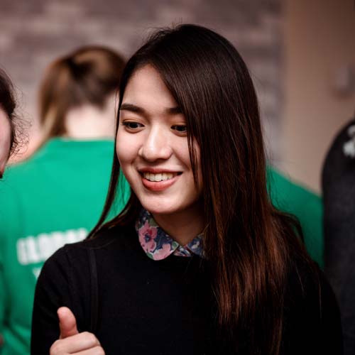 Student smiling at a global campus event